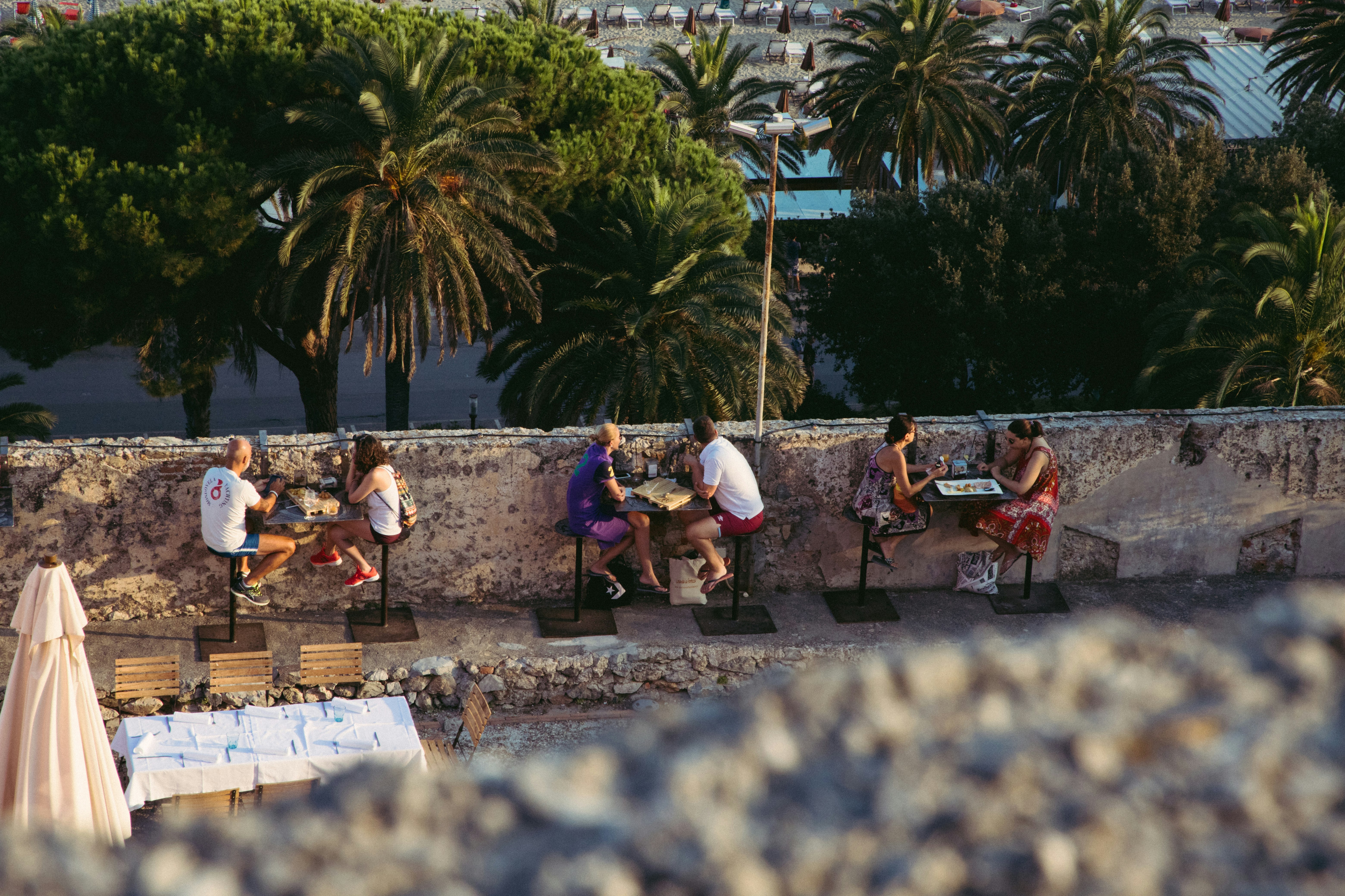 people sitting on white chairs during daytime